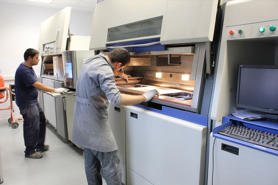 SLS fabrication machines in the Fundació CIM warehouse